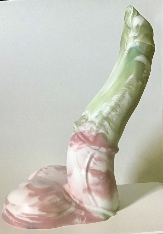 Oisin is curved similarly to a question mark. The top half is a marble of shimmery spring green and white, while the bottom half is a marble of pink and white. The tip is pointed and the base features two balls.
