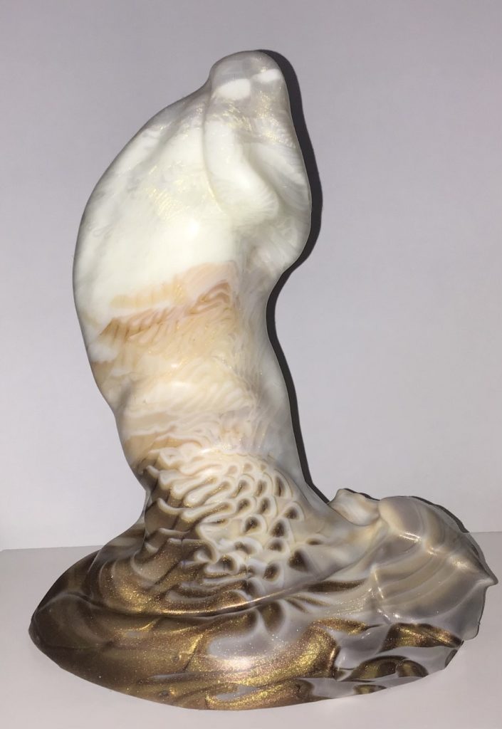 A top-heavy swell with prominent head, two ridges along the side, and a few scales on one side of the base. It's a marble of white with gold shimmer, light orange-brown, and brown, evoking the image of a very creamy iced coffee.
