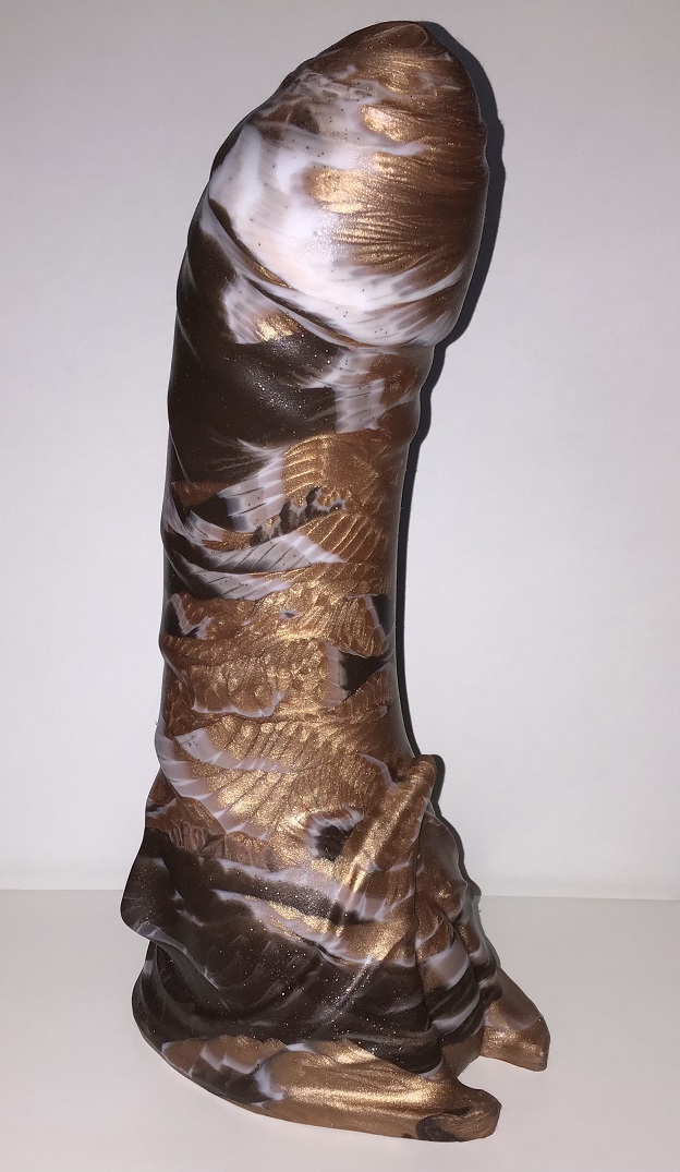 A humanoid model with fins at the base. It's a marble of dark brown, copper, and white. The marble gives a feathery effect. One side of the toy is predominantly copper.