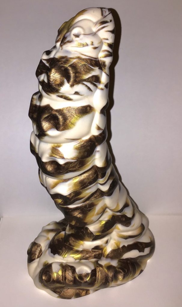 A bug-like tentacle with a strong curve and prominent suckers. It's a marble of cream, gold, and brown.